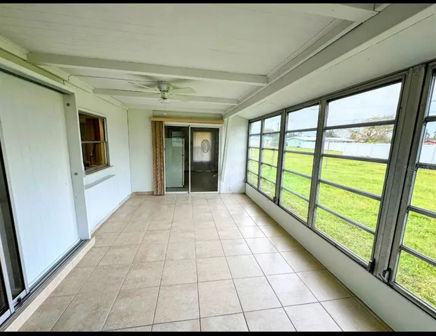 a view of empty room with large windows