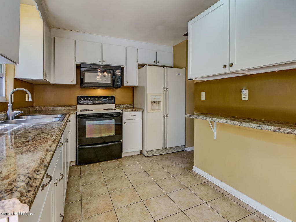 1060 Player Road Jacksonville, FL 32218 - Photo 17 of 37 a kitchen with stainless steel appliances granite countertop a refrigerator stove and sink