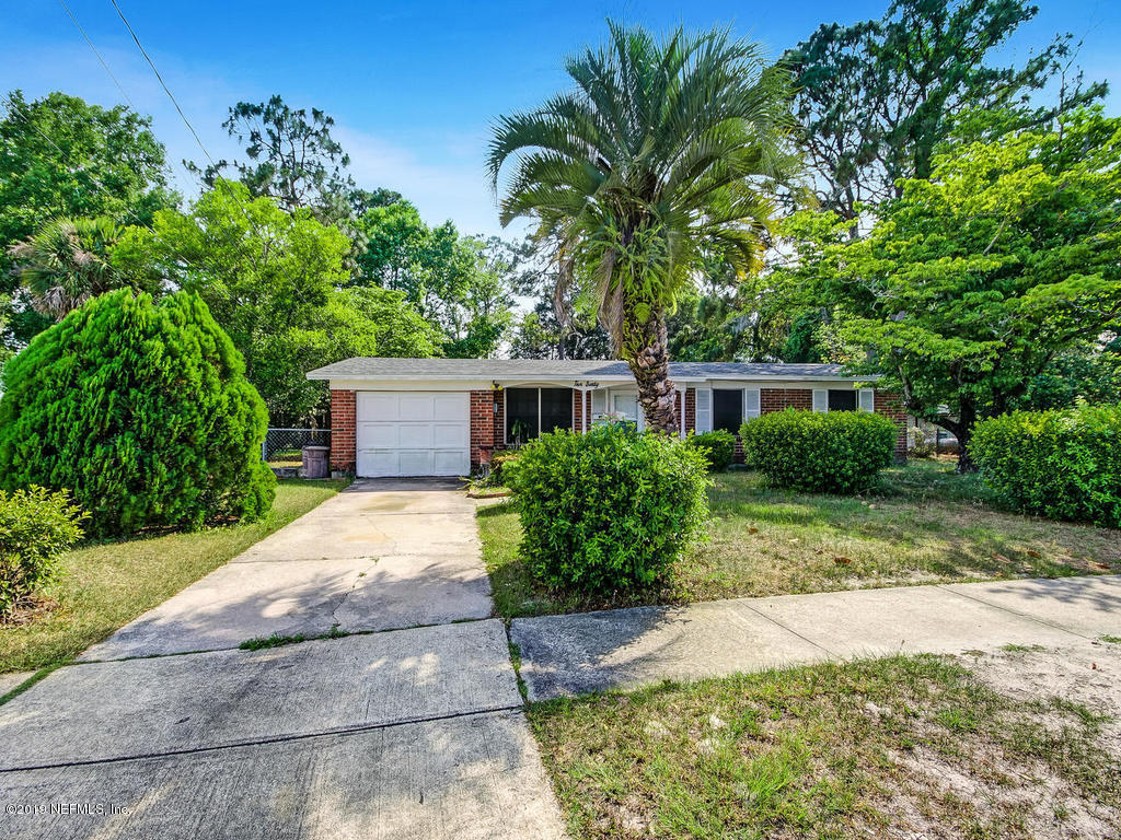 1060 Player Road Jacksonville, FL 32218 - Photo 2 of 37 a front view of a house with a yard and a garage