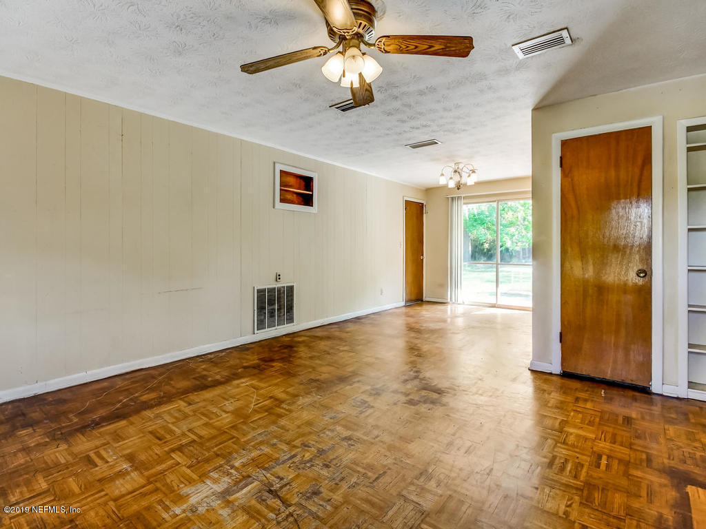 1060 Player Road Jacksonville, FL 32218 - Photo 9 of 37 wooden floor in an empty room with a window