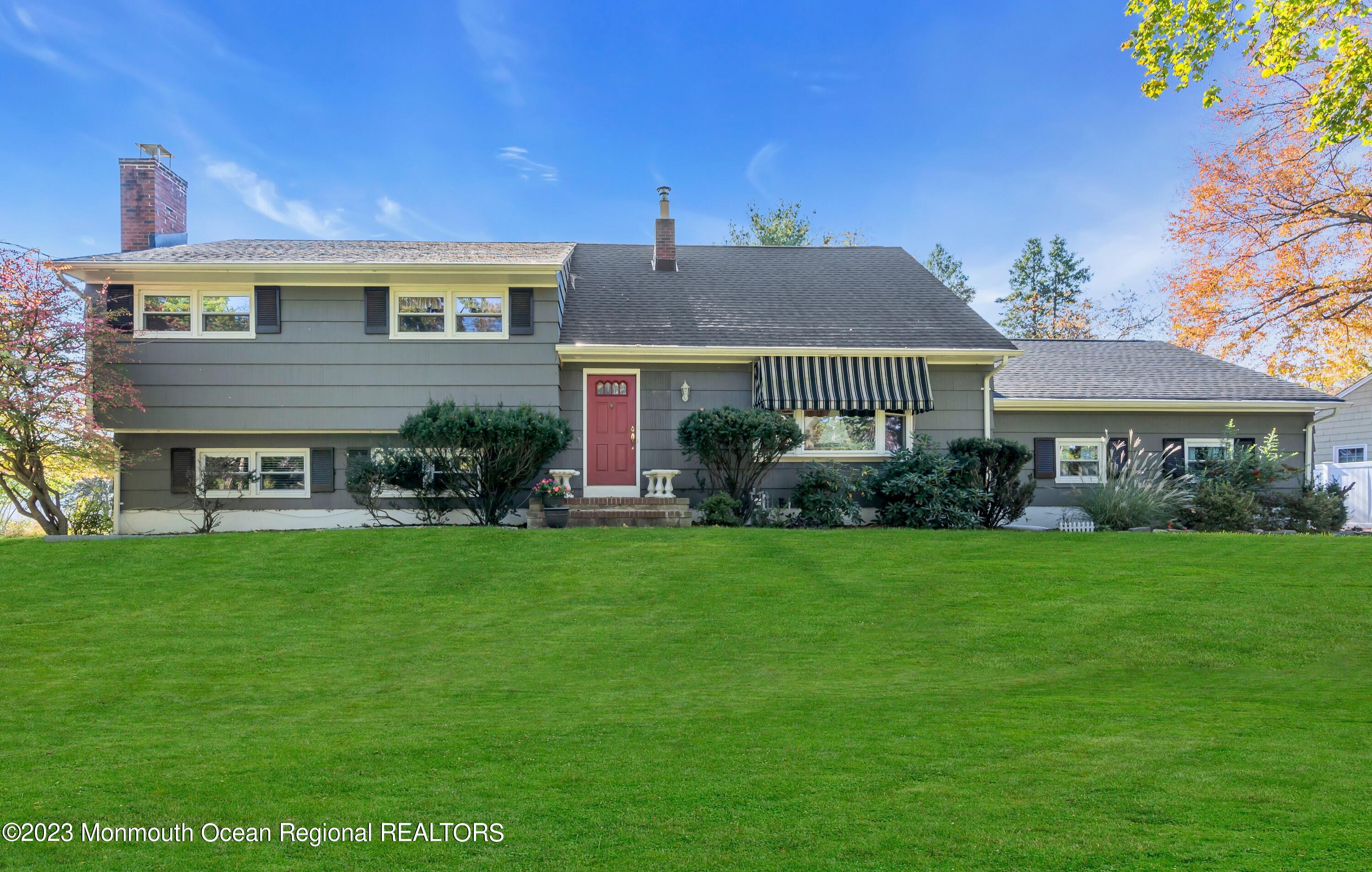 1305 Allaire Road Spring Lake, NJ 07762 - Photo 1 of 27 a front view of a house with a yard and garage