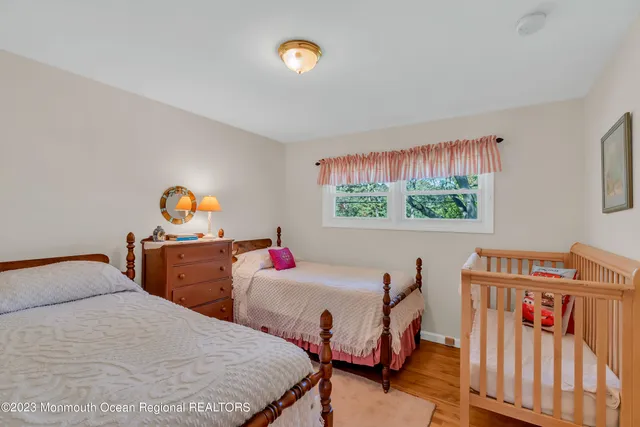 a bedroom with two beds and a desk