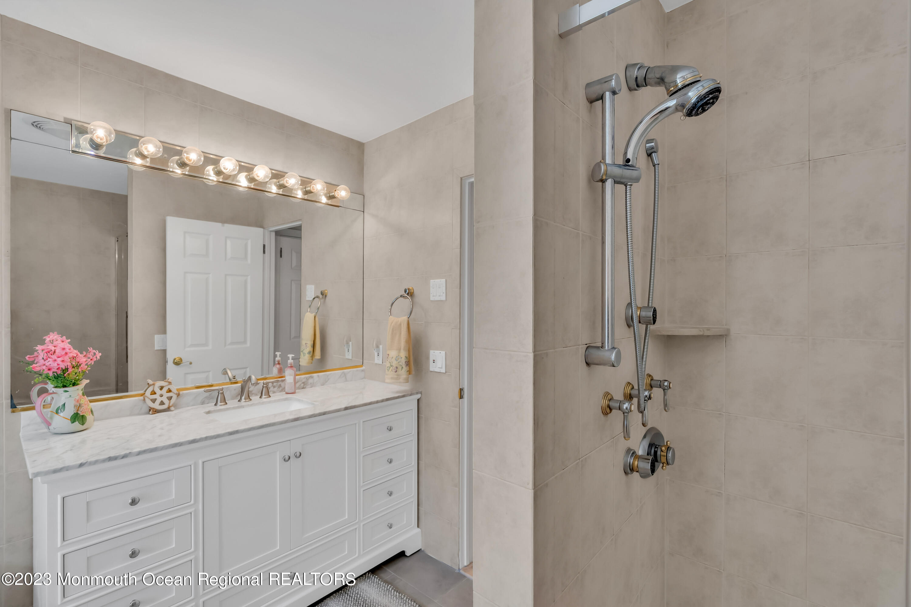 1305 Allaire Road Spring Lake, NJ 07762 - Photo 16 of 27 a bathroom with a double vanity sink mirror and shower