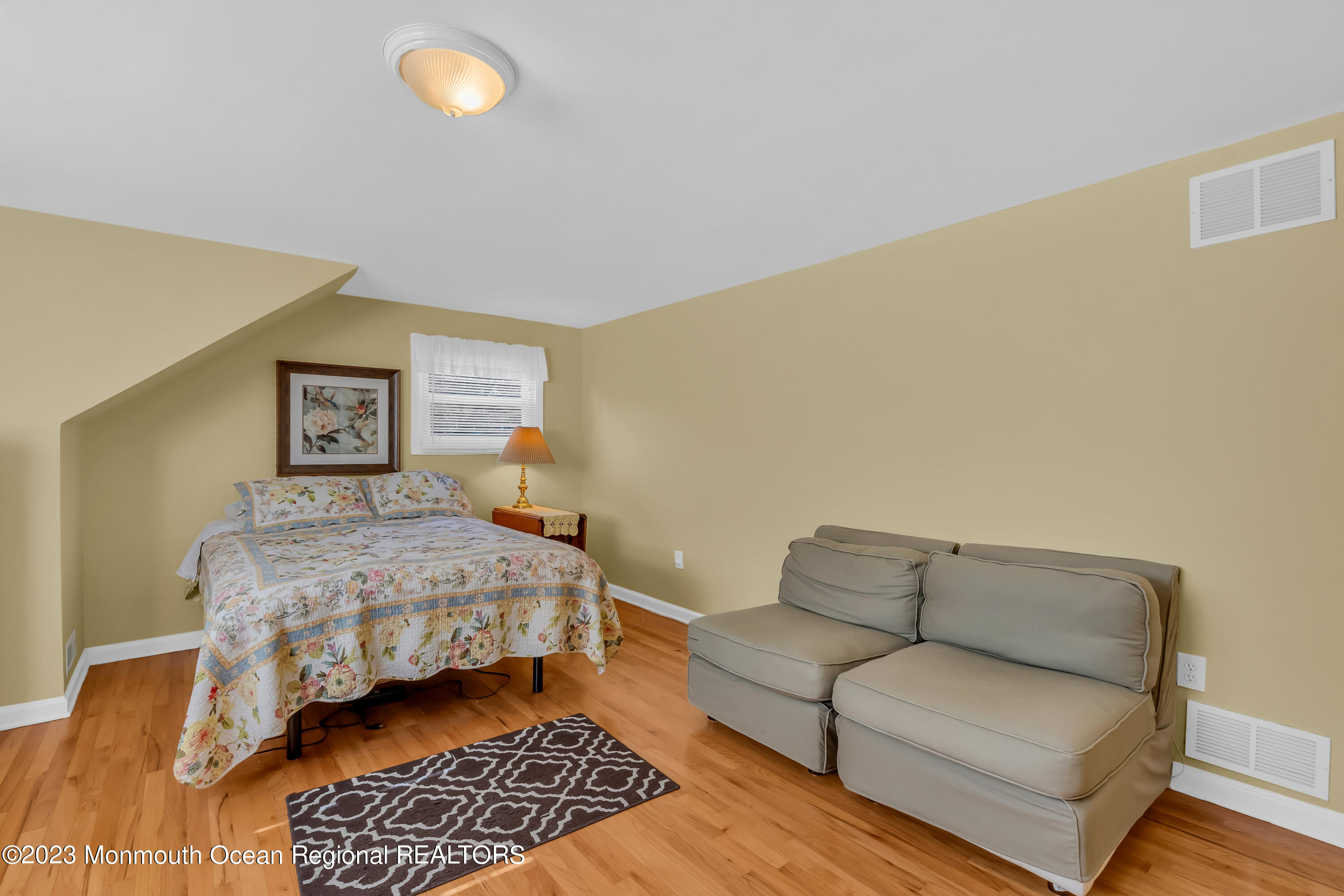 1305 Allaire Road Spring Lake, NJ 07762 - Photo 17 of 27 a bedroom with a bed couch and a night stand