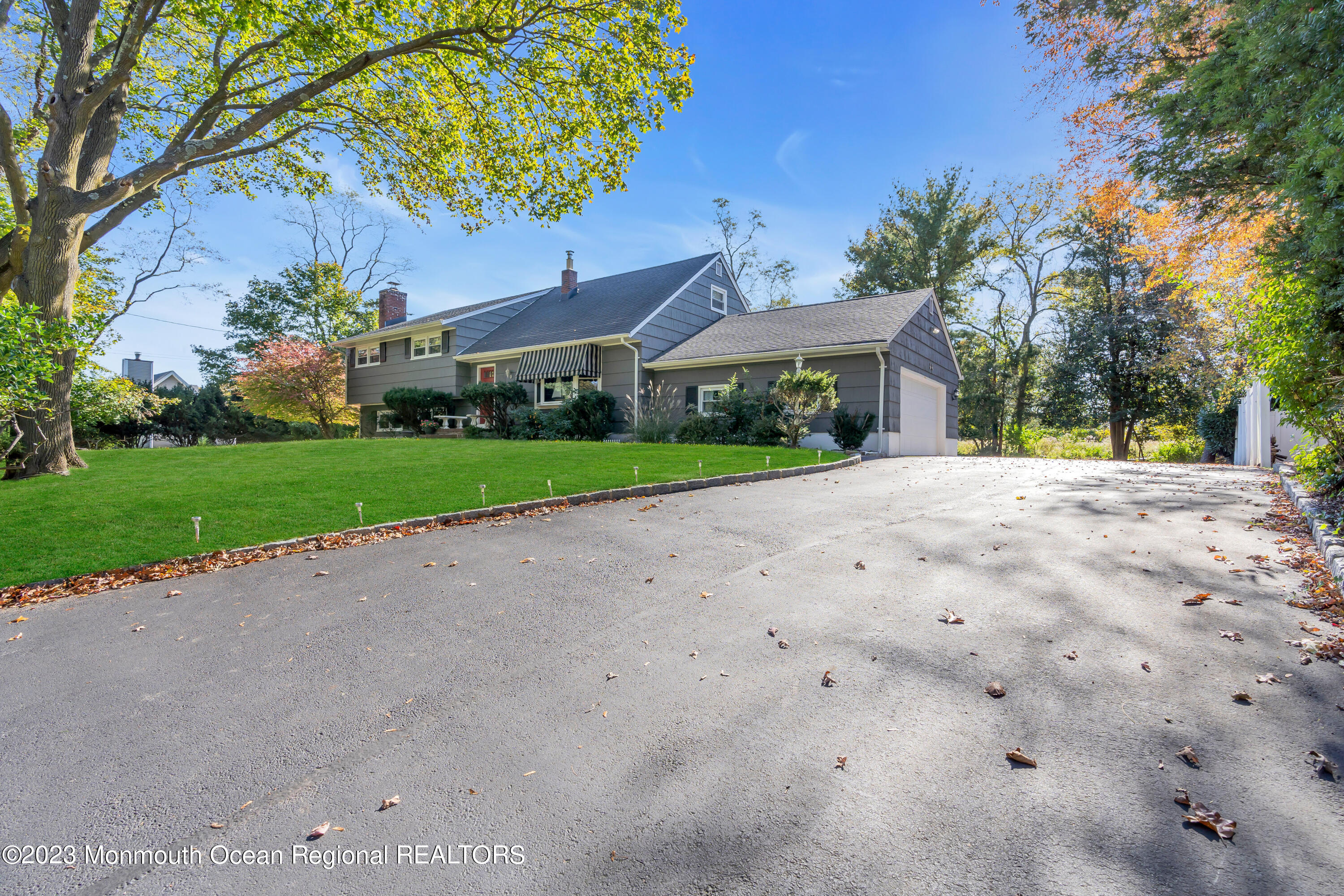 1305 Allaire Road Spring Lake, NJ 07762 - Photo 2 of 27 a front view of a house with a yard and trees