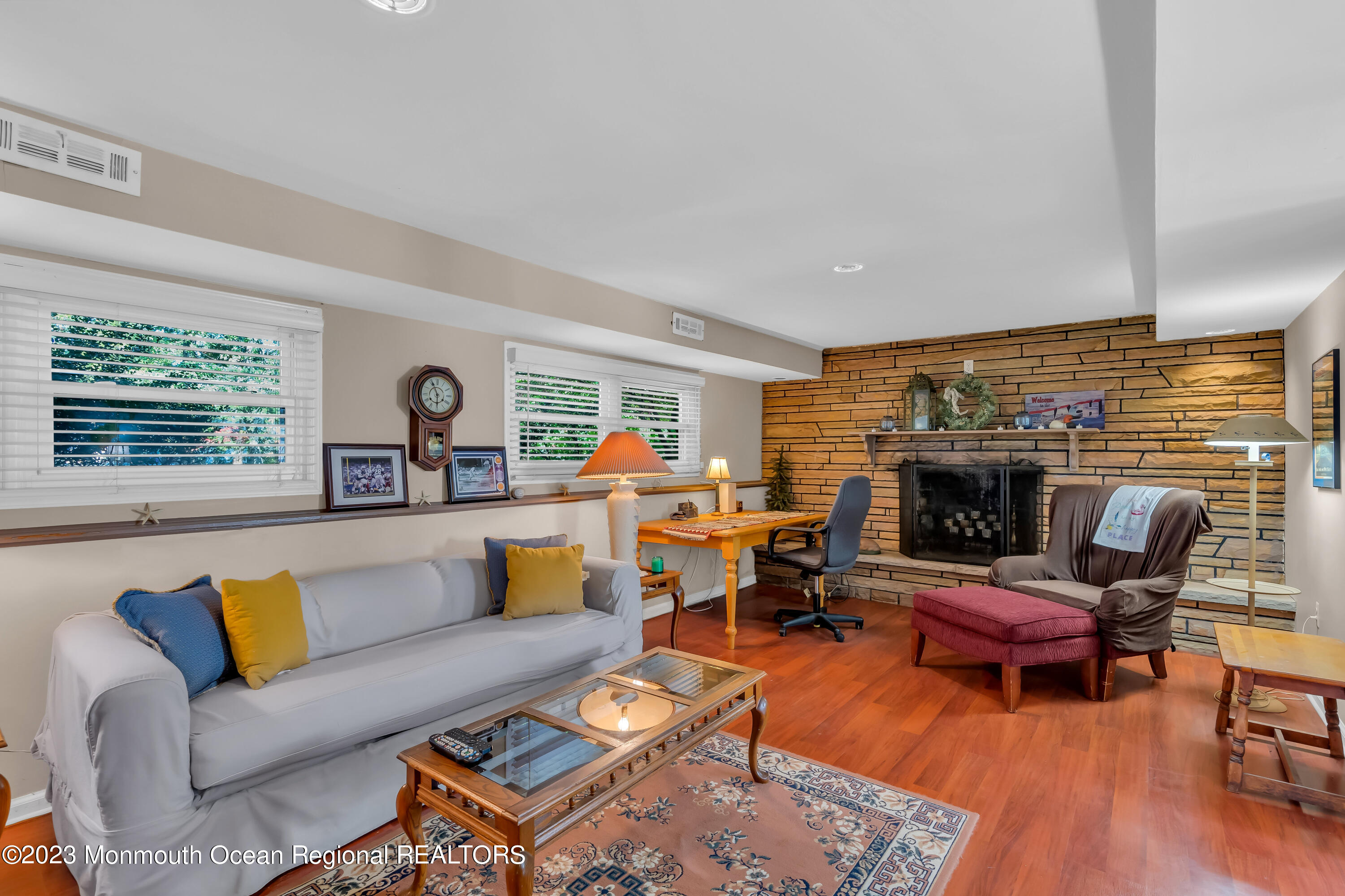 1305 Allaire Road Spring Lake, NJ 07762 - Photo 22 of 27 a living room with furniture fireplace and a large window