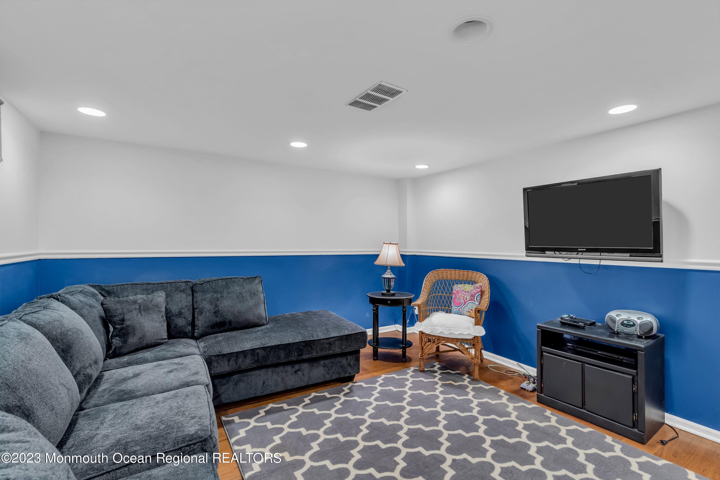 1305 Allaire Road Spring Lake, NJ 07762 - Photo 25 of 27 a living room with furniture and a flat screen tv