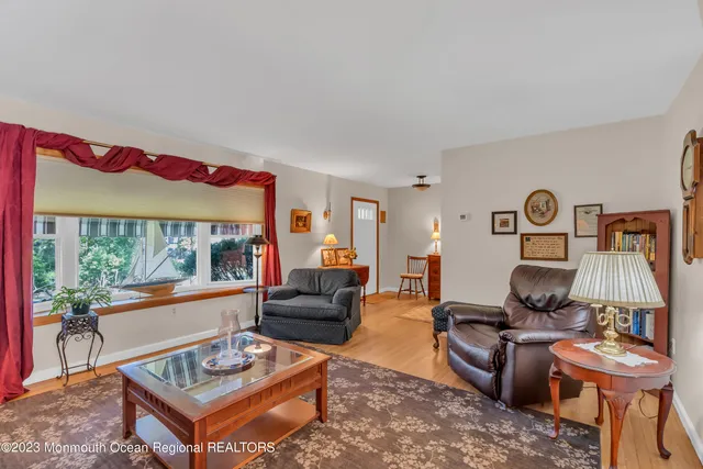 a living room with furniture a rug and a lamp