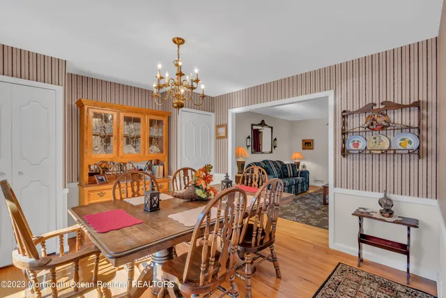 a view of a dining room with furniture and chandelier