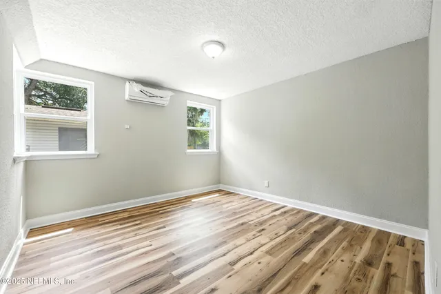 a view of a kitchen with wooden floor and electronic appliances