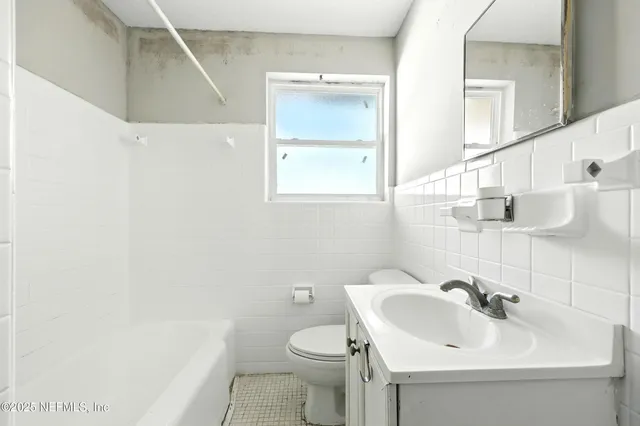 an empty room with wooden floor and a window