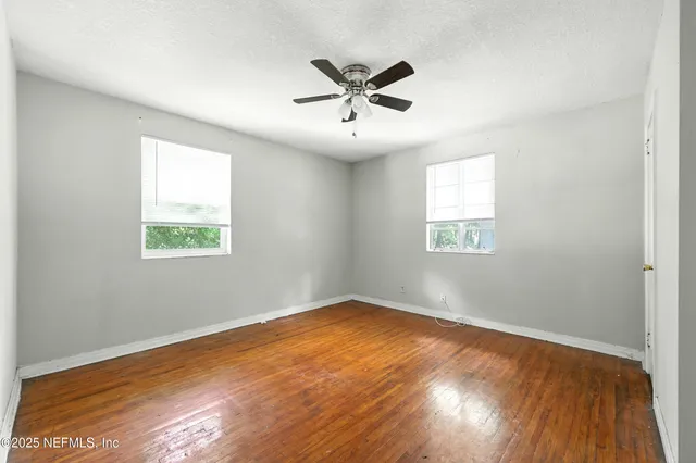 a kitchen with granite countertop white cabinets and stainless steel appliances