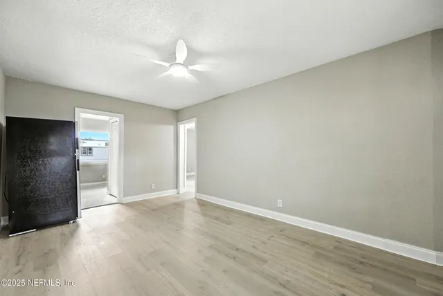 a view of a house with a yard and large tree