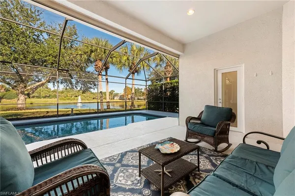 a living room with furniture and a floor to ceiling window
