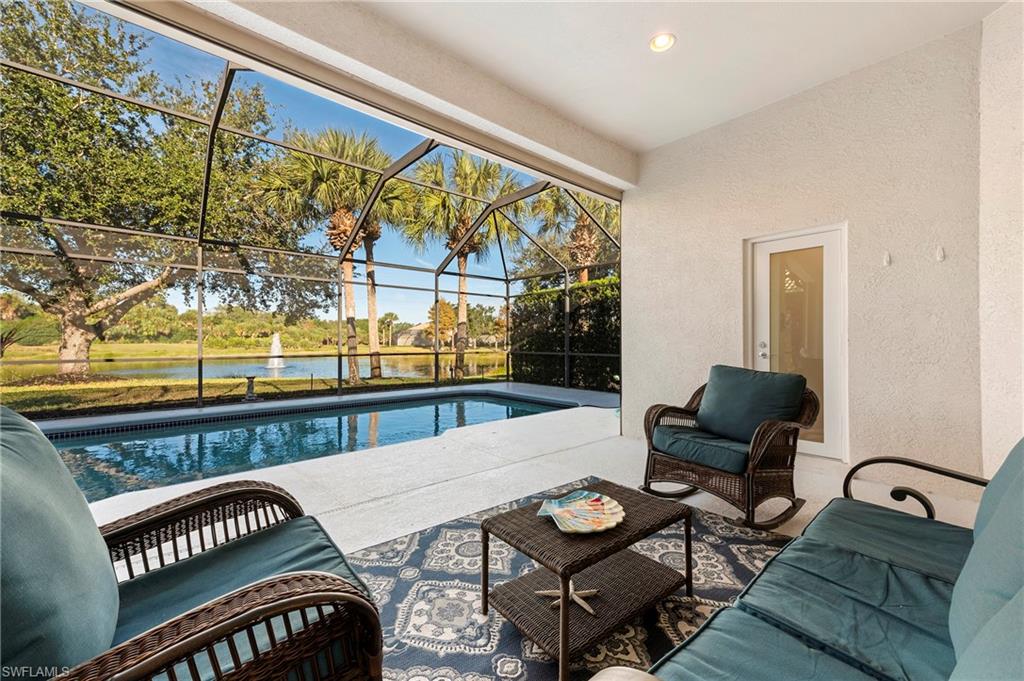 a living room with furniture and a floor to ceiling window