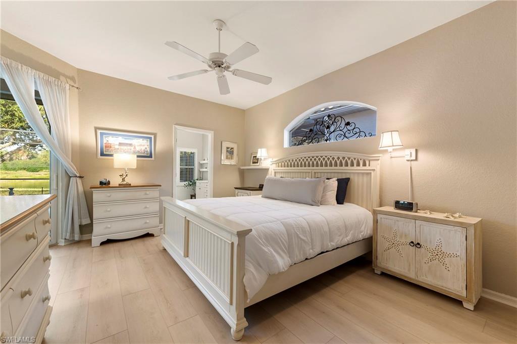 17819 Modena Road Fort Myers, FL 33913 - Photo 13 of 50 a bedroom with a bed a chandelier and dresser