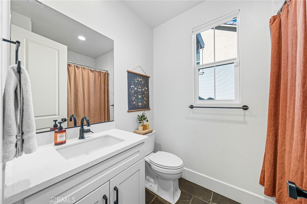 32017 Radiant Drive Temecula, CA 92591 - Photo 27 of 74 a bathroom with a sink a toilet and a mirror