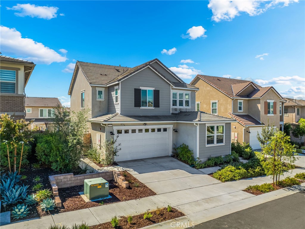 32017 Radiant Drive Temecula, CA 92591 - Photo 3 of 74 a front view of a house with a yard and potted plants