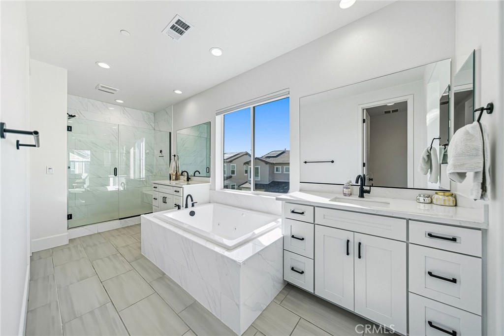 32017 Radiant Drive Temecula, CA 92591 - Photo 41 of 74 a bathroom with a sink double vanity granite tub shower and a mirror