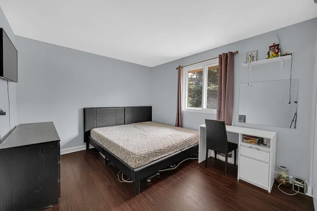 a bed room with a bed and a window