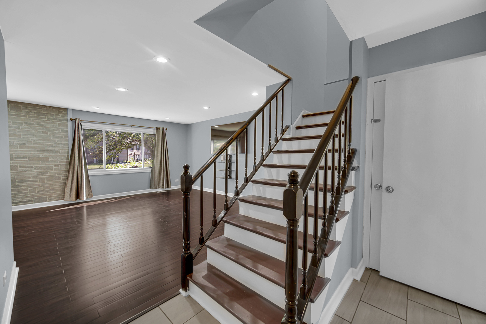 1010 Heathrow Court Wheaton, IL 60189 - Photo 4 of 24 a view of entryway with wooden floor and stairs