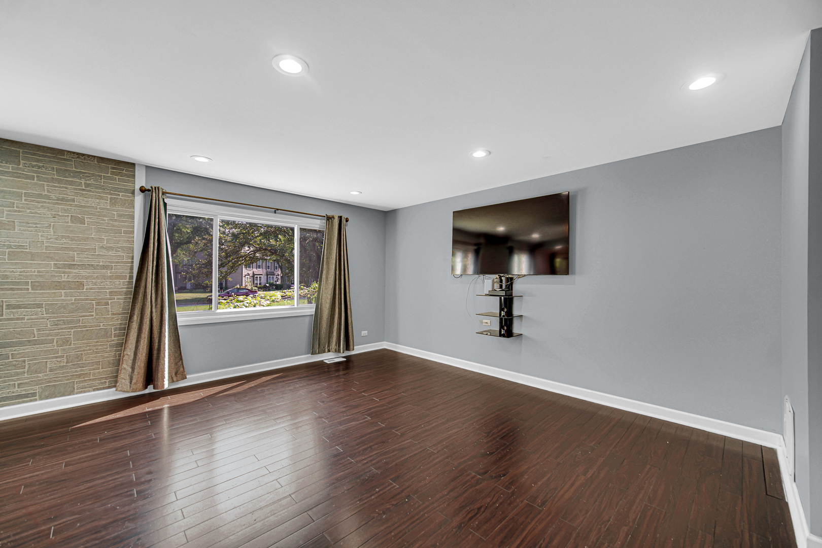 1010 Heathrow Court Wheaton, IL 60189 - Photo 5 of 24 a view of an empty room with wooden floor and a window