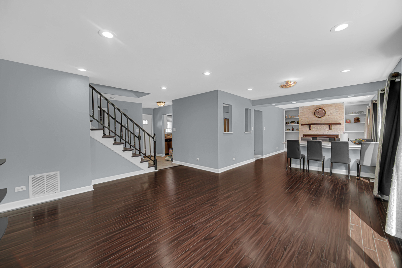 1010 Heathrow Court Wheaton, IL 60189 - Photo 6 of 24 a view of a livingroom with wooden floor and stairs