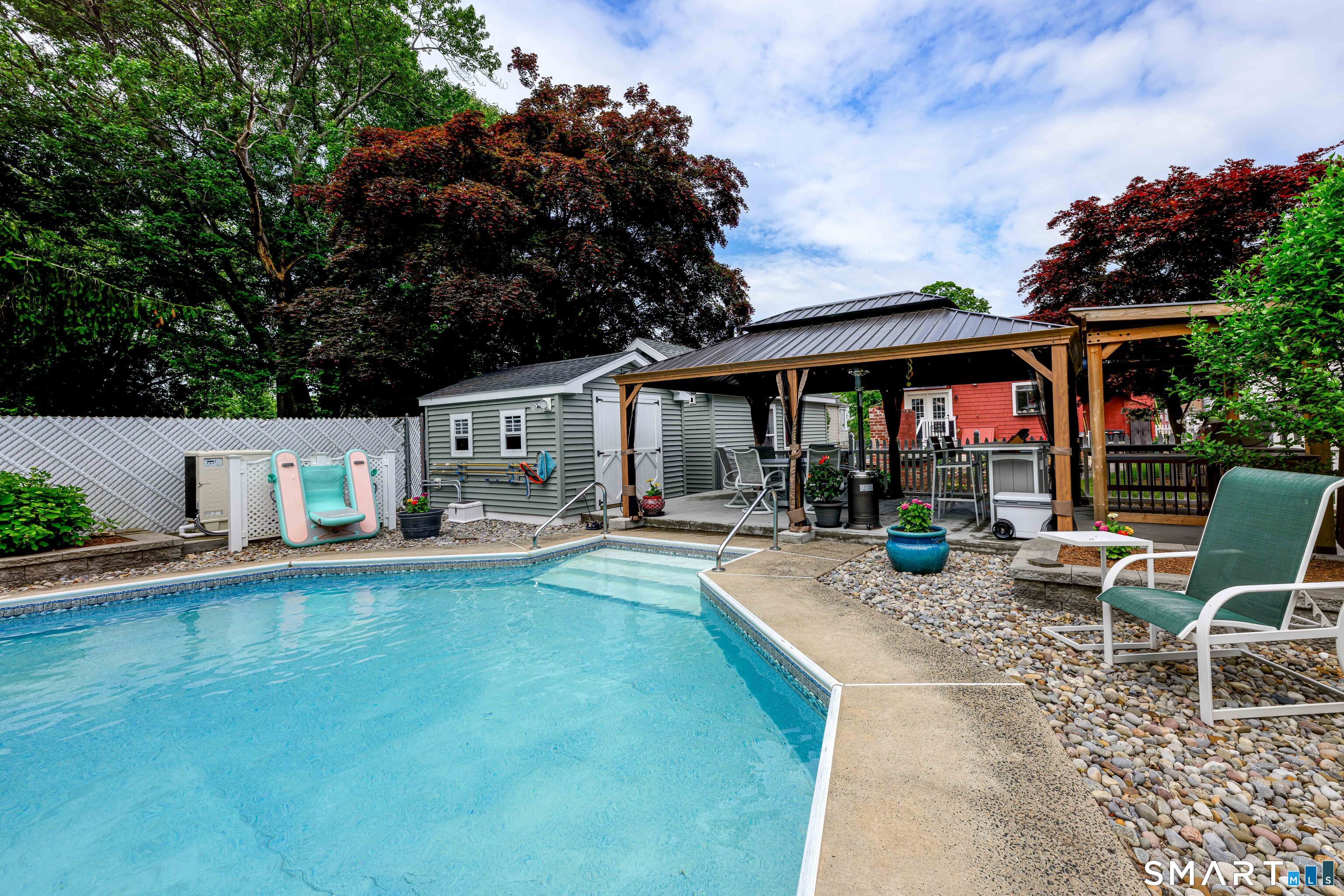 77 Prospect Road East Haven, CT 06512 - Photo 25 of 31 There's a covered cement patio with side covers if needed. Shed can hold all your items for outdoor entertaining and includes a refrigerator!