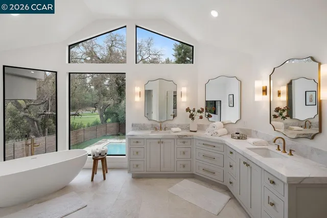 a bathroom with a granite countertop sink mirror and shower
