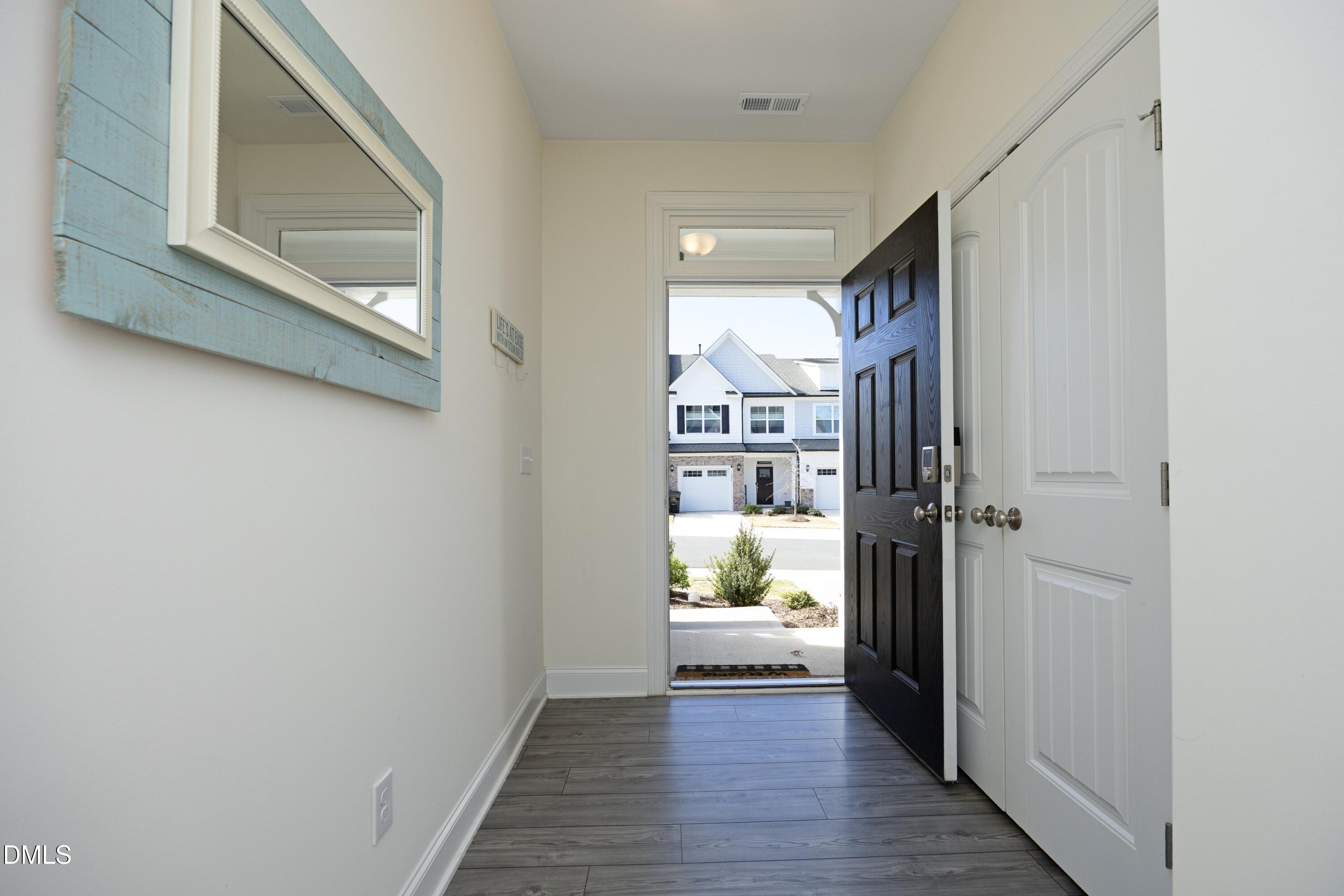 1002 Heartstone Way Durham, NC 27713 - Photo 29 of 35 a view of a hallway view with wooden floor and cabinet