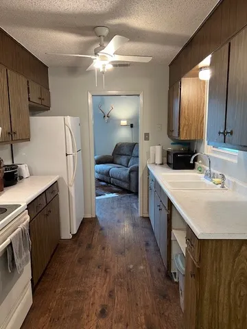 a view of hallway with wooden floor