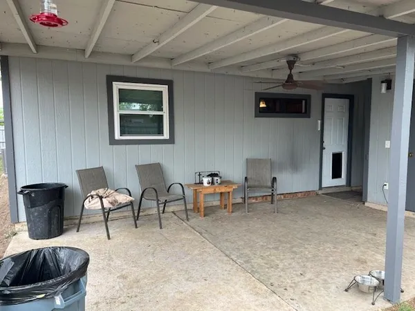 a view of a livingroom with a door and wooden floor