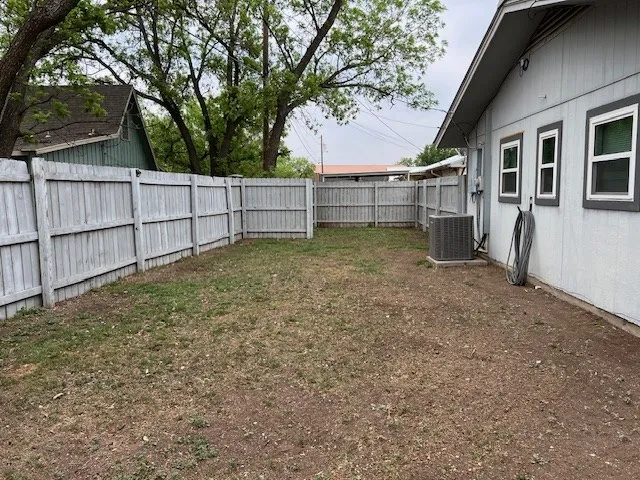 a view of a house with a tree and a yard