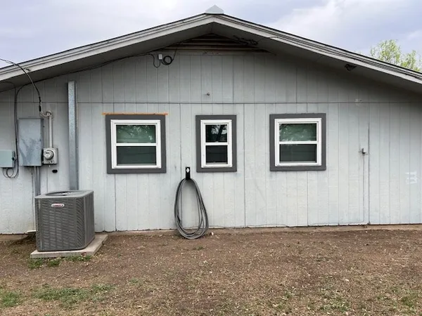 a view of a backyard with large trees