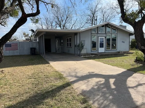 a view of a house with backyard and porch