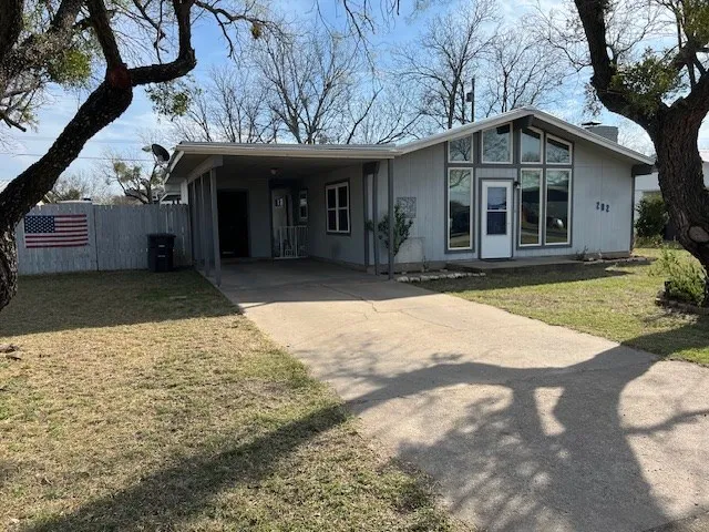 a view of a house with backyard and porch