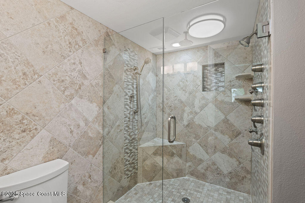 3044 South Hwy A1A, Unit 3C Melbourne Beach, FL 32951 - Photo 14 of 30 a bathroom with a shower and a toilet