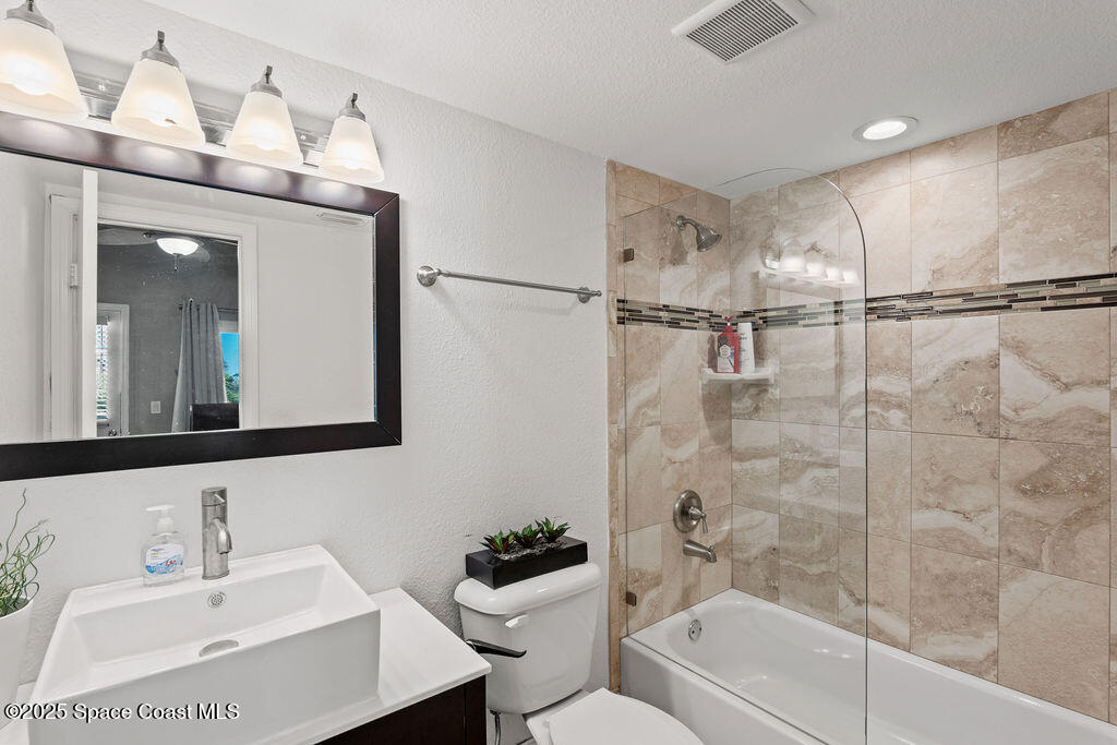 3044 South Hwy A1A, Unit 3C Melbourne Beach, FL 32951 - Photo 18 of 30 a bathroom with a sink mirror toilet and bathtub
