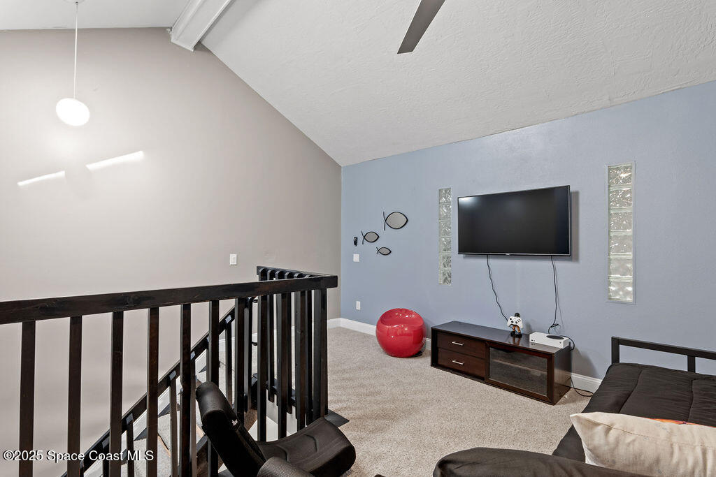 3044 South Hwy A1A, Unit 3C Melbourne Beach, FL 32951 - Photo 20 of 30 a living room with furniture and a flat screen tv