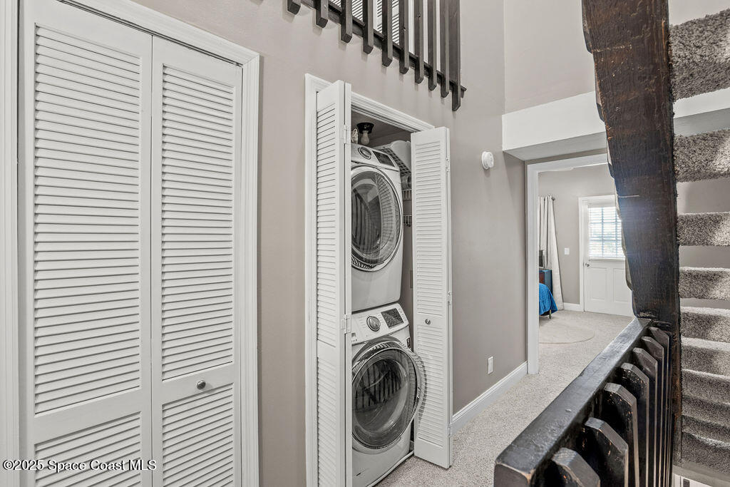 3044 South Hwy A1A, Unit 3C Melbourne Beach, FL 32951 - Photo 21 of 30 a view of a hallway with washer and dryer