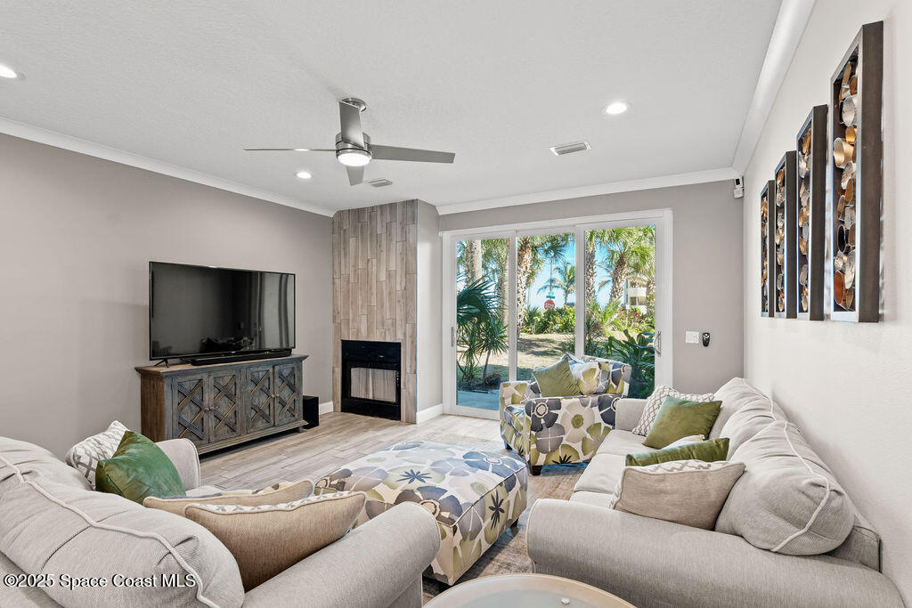 3044 South Hwy A1A, Unit 3C Melbourne Beach, FL 32951 - Photo 7 of 30 a living room with furniture and a flat screen tv