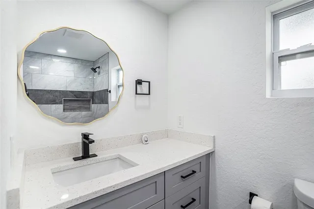 a bathroom with a sink and a mirror