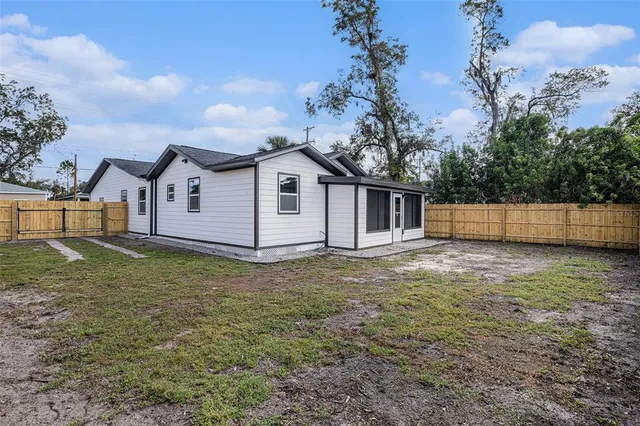 a view of a house with a backyard