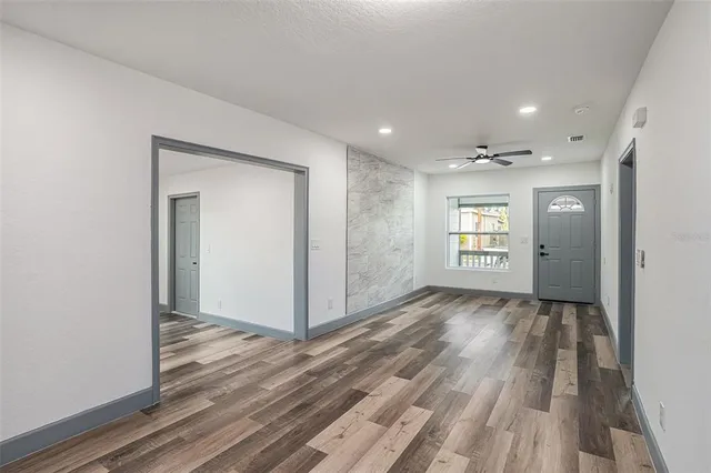 a view of hallway with wooden floor