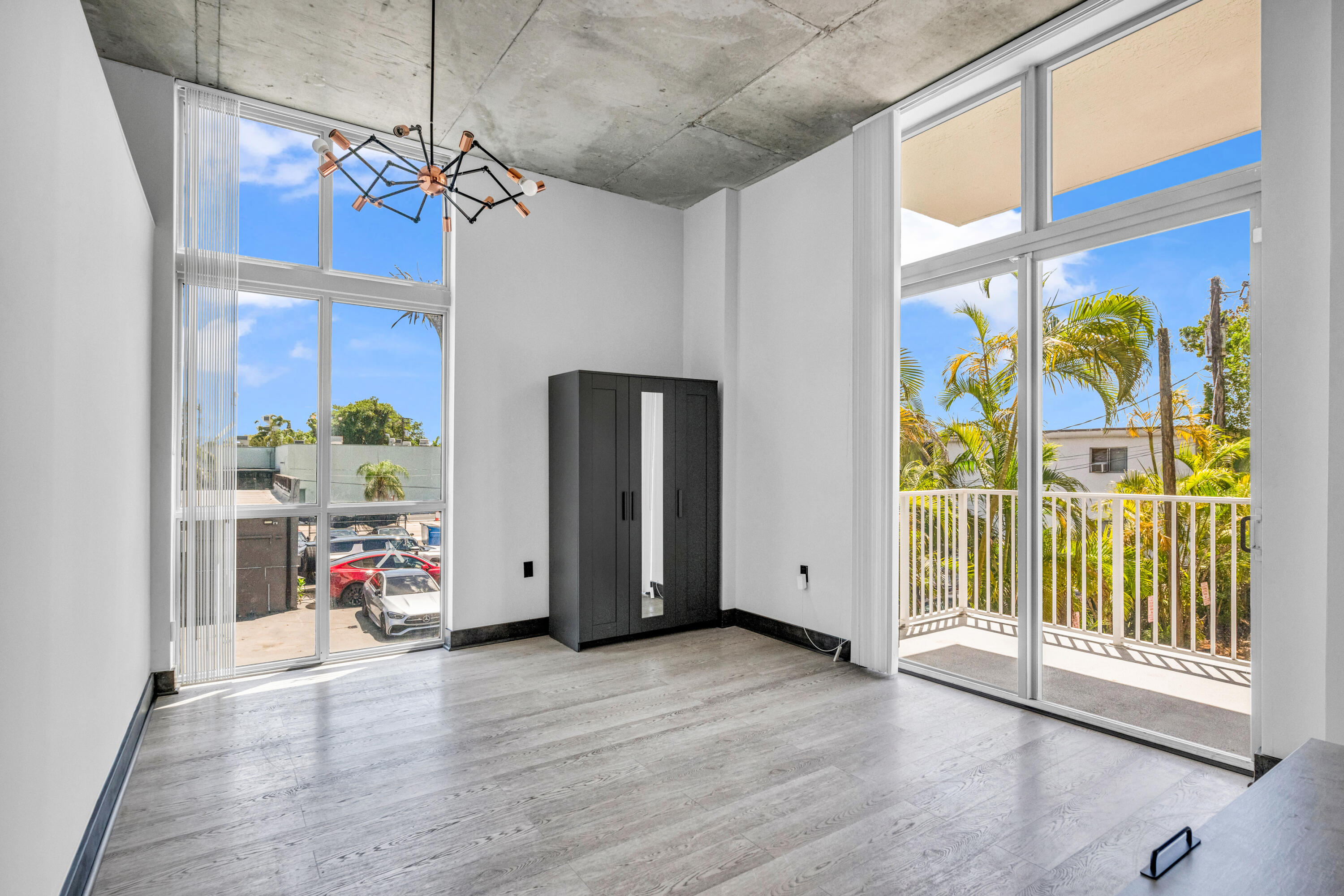 2100 Van Buren Street, Unit 203 Hollywood, FL 33020 - Photo 13 of 28 a view of livingroom with furniture chandelier entryway and wooden floor