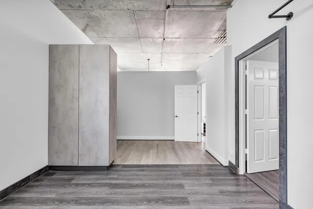 a view of a room with wooden floor