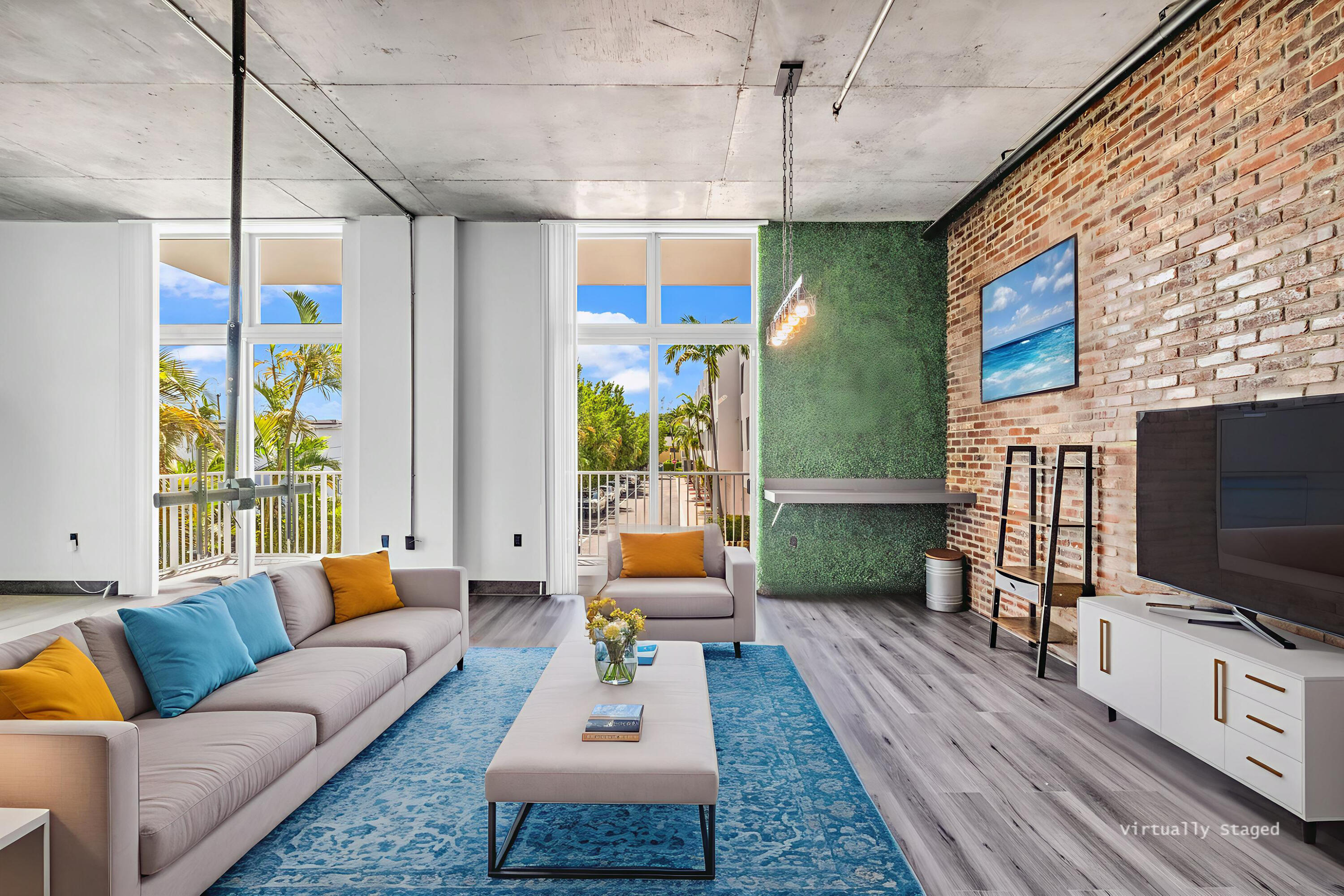 2100 Van Buren Street, Unit 203 Hollywood, FL 33020 - Photo 2 of 28 a living room with patio furniture and a flat screen tv
