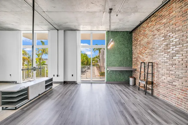 a view of a room with wooden floor and outdoor seating