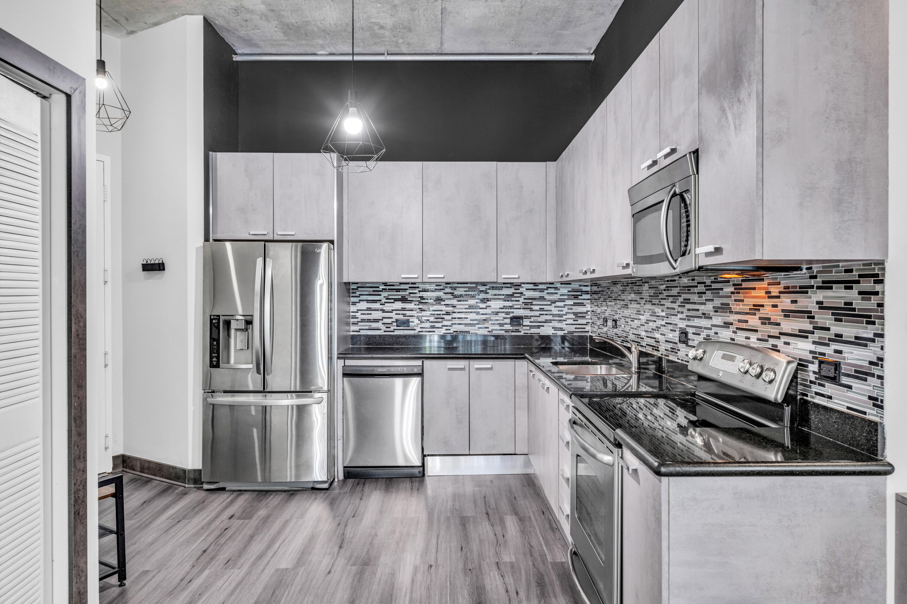 2100 Van Buren Street, Unit 203 Hollywood, FL 33020 - Photo 10 of 28 a kitchen with a sink and steel appliances