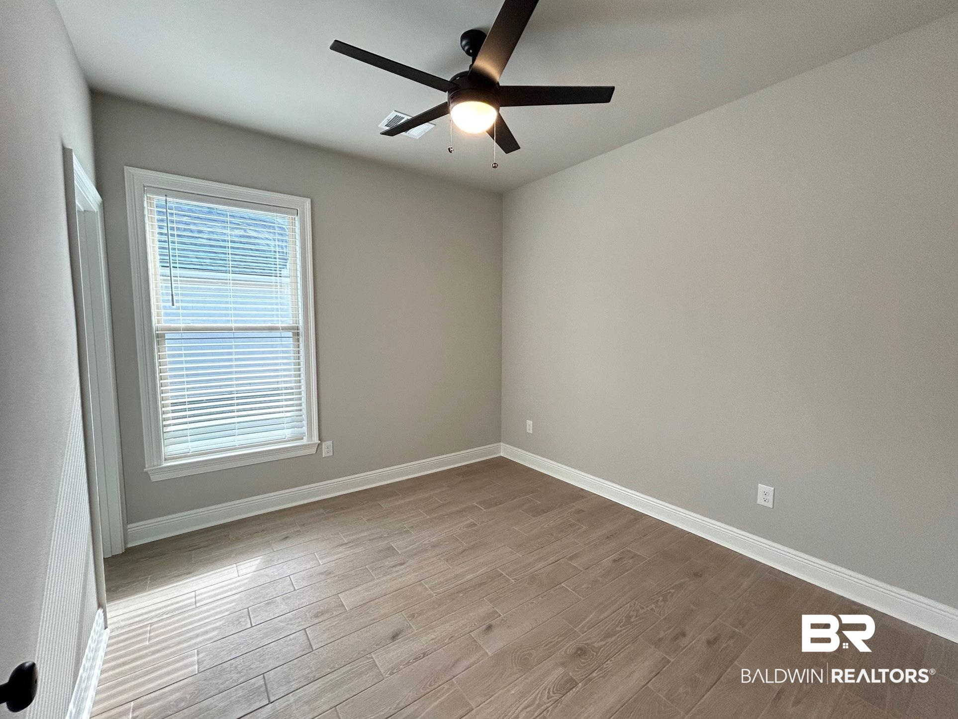 808 Sumter Loop Foley, AL 36535 - Photo 13 of 18 Unfurnished room with ceiling fan and light hardwood / wood-style floors